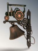 A cast iron traction engine wall bell on bracket, height 34 cm.