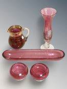 A cranberry glass bud vase, a pair of tealight holders, pen tray and a jug, height 10 cm.