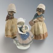 A Lladro figure of a girl carrying a flower pot and two futher matte glazed figures of girls,