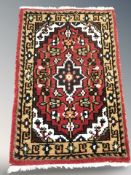 A small Iranian rug, 94 cm x 60 cm.