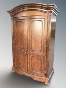 A reproduction bow front double door wardrobe, 138 cm W x 70 cm D x 202 cm H.