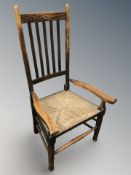 A beech and rattan farmhouse style armchair.