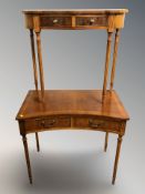 A reproduction yew wood inverted bow front side table, width 86 cm, and a further serpentine table.