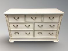 A modern painted seven drawer chest, 147 cm x 54 cm x 85 cm.