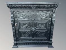 A Victorian ebonised and heavily carved single door side cabinet, 107 cm x 47 cm x 110 cm.