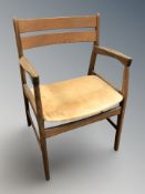 A Danish teak and tan leather armchair.