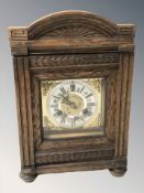 An early 20th century oak eight day bracket clock with brass and silvered dial, height 36 cm,