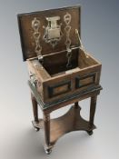 A reproduction continental oak and ebonised strongbox, with hidden lock and key,