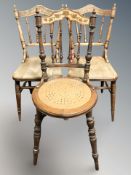 A pair of poker work spindle back chairs and a similar chair.