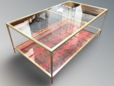 A continental metal framed glass topped two-tier coffee table,