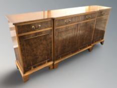 A reproduction yew wood break front sideboard, 193 cm x 44 cm x 87 cm.