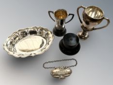 A pierced silver dish, width 13cm, a sherry label, and two trophy cups on ebonised bases.