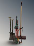 An electric strimmer and several hand tools