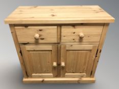 A modern pine side cabinet, fitted cupboards and drawers, 92 cm x 43 cm x 88 cm.