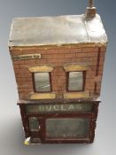 A 20th century scale model railway building with shop front beneath, height 55 cm.