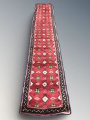 A woolen runner of Persian design,