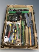 A group of die cast and tin plate locomotives, passenger cars and other rolling stock.