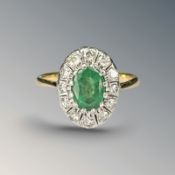 An 18ct gold emerald and diamond ring, size O CONDITION REPORT: 4.