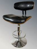 A contemporary chrome laminated wood and black leather rise and fall bar chair.