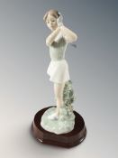A Nao figure of a female golfer, on plinth, height 27 cm, in associated Lladro box.