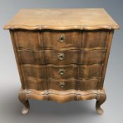 A continental oak serpentine-front four drawer chest,