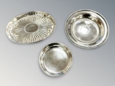 A silver oval shallow tray, width 10.5 cm, and two circular dishes.