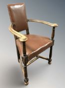 A studded leather upholstered elbow chair and further elm elbow chair.