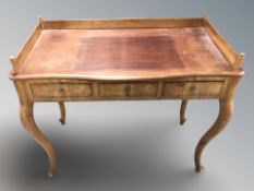 A continental walnut three drawer writing desk on cabriole legs, width 101 cm.