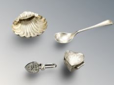 A silver caddy spoon, a shell-shaped dish, a heart-shaped pill box and a heart-shaped clip.