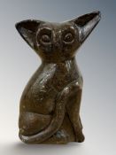 An Inuit soapstone carving of a seated cat, indistinctly signed,