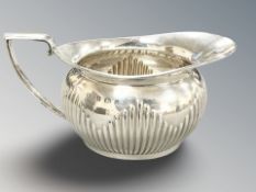 A silver cream jug, Barker Brothers, Birmingham 1902, length 14.5cm.