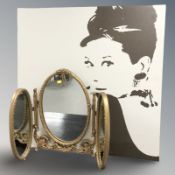 A three fold gilt dressing table mirror,