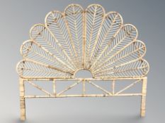 A wicker peacock fan headboard, width 180 cm.