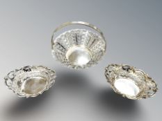 A pierced silver basket, height 7.5 cm, and a similar small pair of baskets.