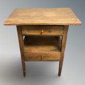 An oak two tier occasional table, fitted drawers, width 57 cm.