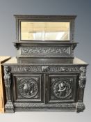 A Victorian heavily carved and ebonised oak double door sideboard, 147 cm W x 65 cm D x 99 cm H,