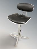 A chrome and black leather swivel rise and fall chair.