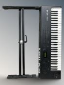 A Kawai K4 16 bit digital synthesizer and a folding keyboard stand.