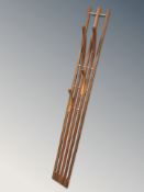 A Scandinavian teak coat rack with protruding hooks,
