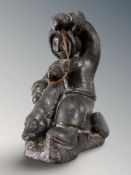 A Canadian Wolf Original carved figure of an Inuit man with seal, height 24 cm.