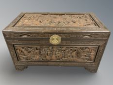 An oriental carved camphor wood blanket chest, 101 cm x 56 cm x 58 cm.