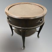 A continental stained four drawer circular occasional table,