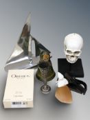 A polished aluminium model of a sailboat, Russian doll, a Calvin Klein aftershave,