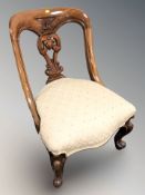 A Victorian style carved mahogany lady's chair.