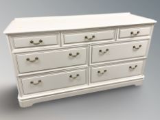 A modern painted seven drawer chest, 150 cm x 48 cm x 82 cm.