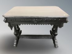 A Victorian heavily carved and ebonised oak library table, fitted a drawer, 107 cm x 68 cm x 75 cm.