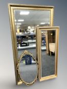 Three reproduction gilt mirrors, largest 135 cm x 74 cm.