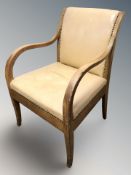 A continental studded leather open armchair, width 59 cm.