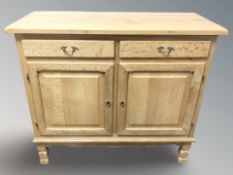 A Danish blonde oak sideboard, fitted cupboards and drawers, 107 cm x 45 cm x 93 cm.