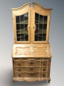 A Danish blonde oak and stained glass bureau bookcase, 104 cm x 50 cm x 209 cm.